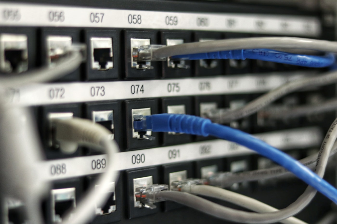 Rows of server racks in a data center corridor