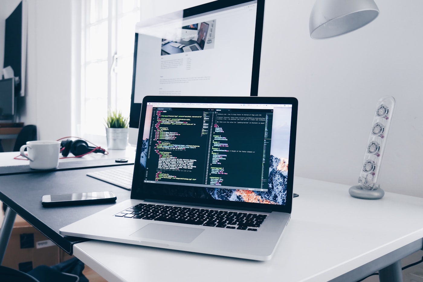 Laptop with code on a desk in a clean workspace